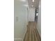 Hallway with clean white walls and laminate floors at 3627 W Palmaire Ave, Phoenix, AZ 85051
