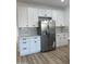 Bright kitchen with white cabinets, stainless steel appliances, subway tile backsplash, and wood-look floors at 3627 W Palmaire Ave, Phoenix, AZ 85051