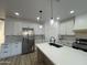 Bright kitchen with white cabinets, stainless steel appliances, subway tile backsplash, and wood-look floors at 3627 W Palmaire Ave, Phoenix, AZ 85051