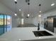 Open floor plan with white cabinets and an island with double sinks and pendant lights at 3627 W Palmaire Ave, Phoenix, AZ 85051