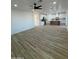 Expansive living space seamlessly connected to the kitchen with wood-look flooring at 3627 W Palmaire Ave, Phoenix, AZ 85051