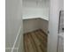 Walk-in pantry with wood-look flooring and custom shelving offers ample storage at 3627 W Palmaire Ave, Phoenix, AZ 85051