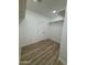 Bright walk-in closet with wood-look floors, a door, and ample shelving at 3627 W Palmaire Ave, Phoenix, AZ 85051