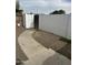 Backyard featuring a walled-in patio with gravel ground cover and a charming walkway leading to a gate at 3646 N 67Th Ave # 64, Phoenix, AZ 85033