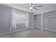 Bright, airy bedroom with light wood floors, sheer curtains, and closet at 3646 N 67Th Ave # 64, Phoenix, AZ 85033