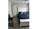 Comfortable bedroom featuring a white bed frame, a navy blue quilt and light gray walls at 3646 N 67Th Ave # 64, Phoenix, AZ 85033