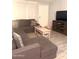 Inviting living room featuring tile flooring, a cozy sectional couch and natural light at 3646 N 67Th Ave # 64, Phoenix, AZ 85033