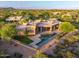 An aerial view captures the rear of the property, complete with a pool, patio, and desert landscaping at 40858 N 109Th Pl, Scottsdale, AZ 85262