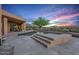 Stunning backyard featuring a sparkling pool, stone patio, and desert landscaping at 40858 N 109Th Pl, Scottsdale, AZ 85262
