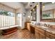 Luxurious bathroom showcasing a freestanding tub, granite counters, and wood cabinets at 40858 N 109Th Pl, Scottsdale, AZ 85262