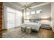 Bright bedroom featuring a large window, ceiling fan, and plush bed with decorative pillows at 40858 N 109Th Pl, Scottsdale, AZ 85262