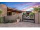 Well-manicured home exterior with desert landscaping and a gated entrance at 40858 N 109Th Pl, Scottsdale, AZ 85262