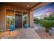 Inviting home entrance with brick pathway, desert landscaping, and large windows showcasing the interior at 40858 N 109Th Pl, Scottsdale, AZ 85262
