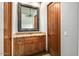 Stylish powder room featuring granite counters, wood cabinetry, and a decorative mirror at 40858 N 109Th Pl, Scottsdale, AZ 85262
