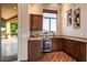 Charming wet bar with custom cabinets, granite countertop, beverage center, and wood flooring at 40858 N 109Th Pl, Scottsdale, AZ 85262