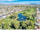 Enjoy the green view of the golf course and pond, with distant mountain views from this aerial shot at 425 S Parkcrest -- # 323, Mesa, AZ 85206