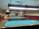 Bright community billiards room with multiple pool tables, seating, and a television for the residents at 425 S Parkcrest -- # 323, Mesa, AZ 85206