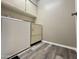 Laundry room with wood-look flooring, washer, dryer, and storage cabinets at 425 S Parkcrest -- # 323, Mesa, AZ 85206