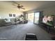 Spacious living room featuring a sliding glass door to the balcony, comfortable seating, and a ceiling fan at 425 S Parkcrest -- # 323, Mesa, AZ 85206