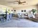 Open living area with carpet, a sofa, dining table, a ceiling fan, and view into the kitchen at 425 S Parkcrest -- # 323, Mesa, AZ 85206