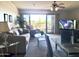 Inviting living room with a ceiling fan, comfortable seating, and a sliding glass door to the balcony at 425 S Parkcrest -- # 323, Mesa, AZ 85206
