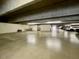 A well-lit parking garage for residents with visible parking spots and smooth cement flooring at 425 S Parkcrest -- # 323, Mesa, AZ 85206