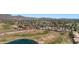 Breathtaking aerial perspective capturing the golf course, a tranquil lake, tree lined streets and houses with red tile roofs at 4346 E Bannock St, Phoenix, AZ 85044