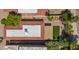 A bird's eye view of a backyard featuring an artificial turf lawn, a covered patio, and desert landscaping at 4346 E Bannock St, Phoenix, AZ 85044