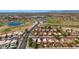 Community aerial showcasing mature trees, a sprawling green golf course with a peaceful lake, and houses with red tile roofs at 4346 E Bannock St, Phoenix, AZ 85044