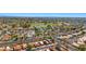 Beautiful aerial view of the community with red tiled roofs, green lawns, lake and mature tree lined streets in the area at 4346 E Bannock St, Phoenix, AZ 85044