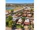 Stunning aerial view of a neighborhood featuring homes with red tile roofs, lush landscaping, and a nearby lake and golf course at 4346 E Bannock St, Phoenix, AZ 85044
