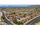 Expansive aerial shot showcasing a community with red-tiled roofs, lush green spaces, and a scenic golf course with water features at 4346 E Bannock St, Phoenix, AZ 85044