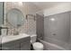 Cozy bathroom with a single sink vanity, decorative mirror, and combined tub and shower at 4346 E Bannock St, Phoenix, AZ 85044