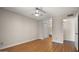 Bedroom with wood flooring, ceiling fan, closet doors, and entry to the bathroom at 4346 E Bannock St, Phoenix, AZ 85044