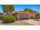 Lovely home with a well-manicured yard and a two-car garage, featuring a red tile roof and desert landscaping at 4346 E Bannock St, Phoenix, AZ 85044
