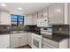 The kitchen features sleek black countertops with stylish tiled backsplash for modern flair at 4346 E Bannock St, Phoenix, AZ 85044