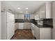 A view of the kitchen featuring white appliances, tiled floors, and updated countertops at 4346 E Bannock St, Phoenix, AZ 85044