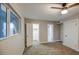 Bright bedroom with a window, neutral carpet, multiple closets, and ample natural light at 5222 N 41St Ave, Phoenix, AZ 85019