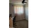 Bedroom with a window, neutral carpet, and space for an office or desk at 5222 N 41St Ave, Phoenix, AZ 85019