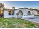 Charming home featuring an arched entryway, a modern design, and a well-maintained lawn at 5222 N 41St Ave, Phoenix, AZ 85019