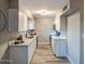 Updated kitchen with white cabinets, sleek countertops, stainless steel appliances, and modern fixtures at 5222 N 41St Ave, Phoenix, AZ 85019