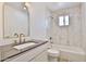 Chic bathroom with marble tile, vanity and an oversized, arched mirror at 5510 E Dallas St, Mesa, AZ 85205