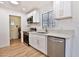 Modern kitchen with white cabinetry, stainless steel appliances, and sleek countertops at 5510 E Dallas St, Mesa, AZ 85205