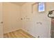 Functional laundry room with a painted brick wall, wood look floors and hookups at 5510 E Dallas St, Mesa, AZ 85205