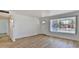 Sunny living room with modern wood flooring, a front door, and a large window at 5510 E Dallas St, Mesa, AZ 85205