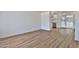 Bright living room featuring sleek wood flooring and access to the kitchen at 5510 E Dallas St, Mesa, AZ 85205