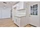 Bright mud room featuring white cabinets, quartz countertops, and a convenient exterior door at 5510 E Dallas St, Mesa, AZ 85205