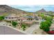 Aerial view of a house showcasing its solar panels, desert landscape, and mountain backdrop at 5812 W Spur Dr, Phoenix, AZ 85083