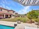 Spacious backyard with pool, manicured lawn, and covered patio, ideal for outdoor living at 5812 W Spur Dr, Phoenix, AZ 85083