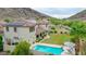 Inviting backyard with a sparkling pool, lush lawn, and space for outdoor entertaining at 5812 W Spur Dr, Phoenix, AZ 85083